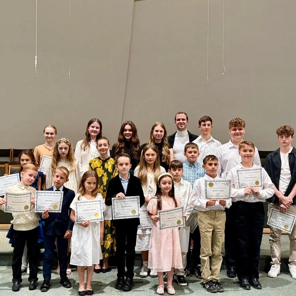 Academy students on stage with their certificates after a recital