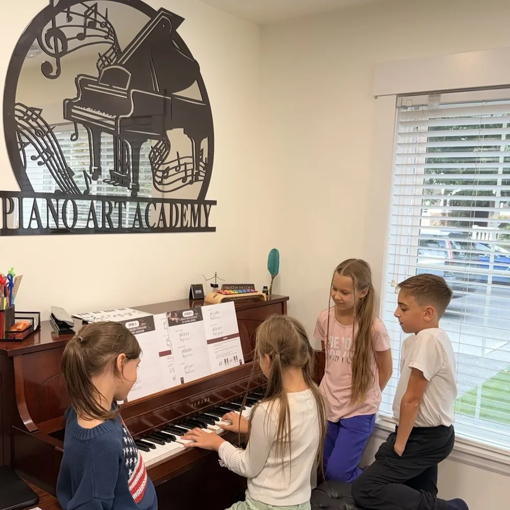 Children gathered at the piano under the Piano Art Academy sign